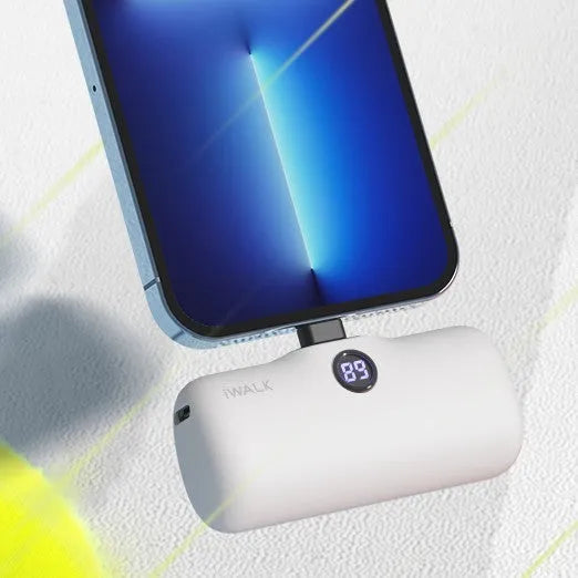 White mini lipstick-shaped power bank showing built-in screen display on black background