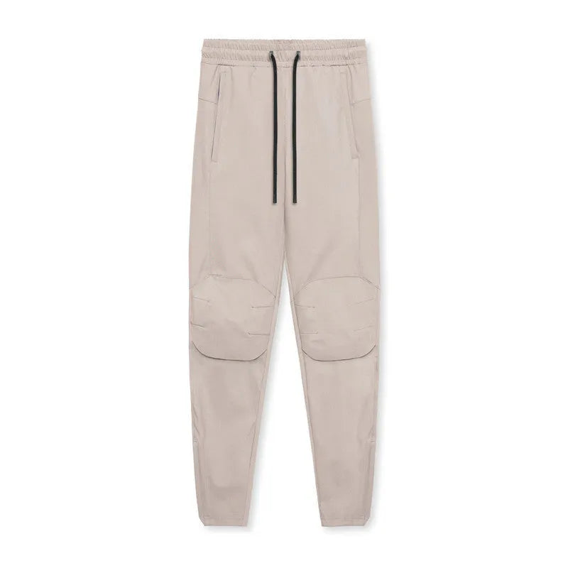 Men's loose grey ankle-tied fitness pants with a casual cut for running and gym workouts.