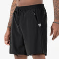 Man wearing black ice silk quick-drying sports shorts with drawstring waist.
