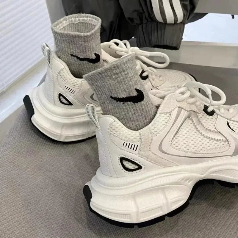 Beige mesh platform sports shoes with a wedge heel and front lace-up fastening.