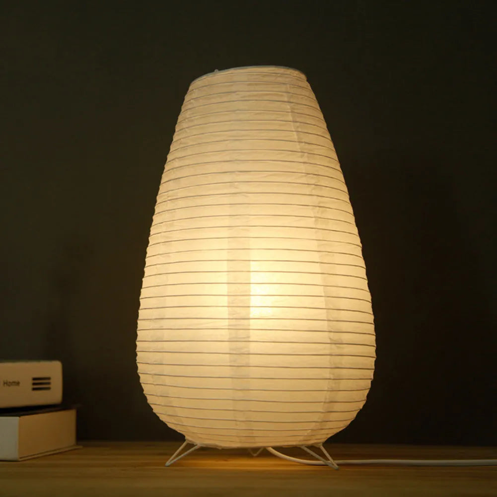 White rice paper plug-in table lamp with traditional shade on wooden surface