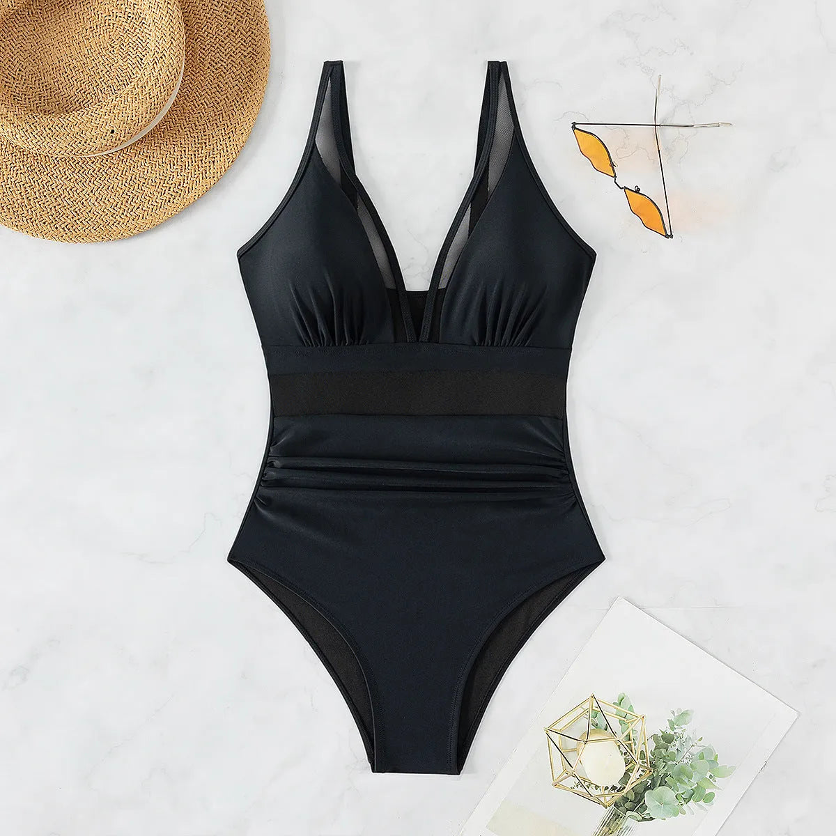 Black halter neck one-piece swimsuit with brief-style bottom on a female mannequin.