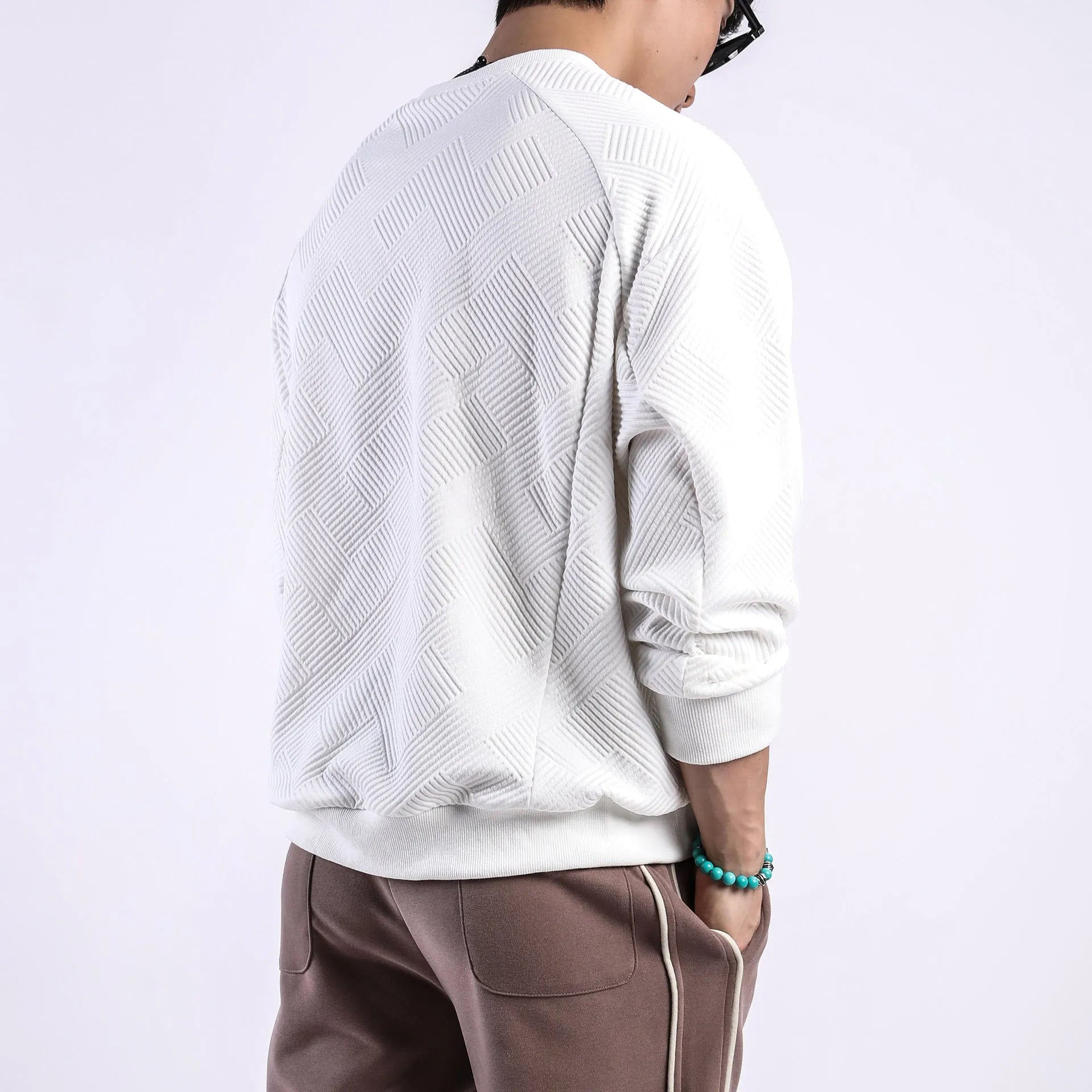 Men's loose fit long-sleeved twill jacquard sweater in Army Green, shown with round neck and regular sleeves.