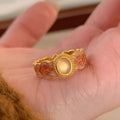 Women's geometric open ring with pink crystal enamel finish on adjustable copper gold plating