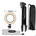 Adjustable silver live phone stand with tripod base extended to full height holding a mobile phone.