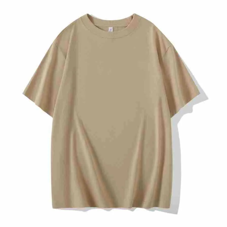 Man wearing a heavyweight dark grey drop shoulder T-shirt with layered shoulder detail.