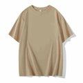 Man wearing a heavyweight dark grey drop shoulder T-shirt with layered shoulder detail.