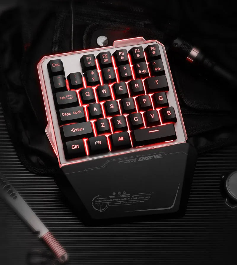 G40 Flow black one-handed robotic keyboard with RGB backlight on a desk.