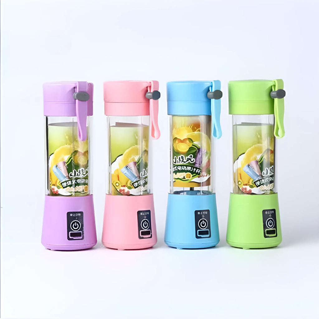 Mini USB electric fruit juicer with pink 400ml cup and stainless steel blades on a table.