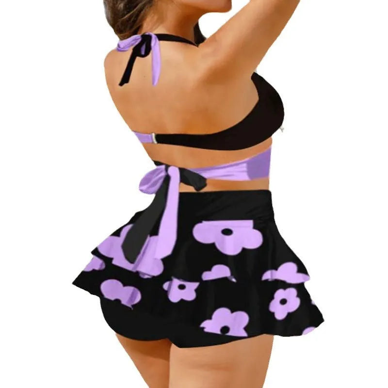 Black high-waist women's bikini with lace-up back and matching swim skirt laid flat.