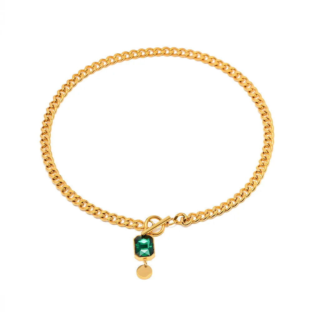 Gold French retro necklace with round geometric pendant featuring emerald zircon stone on Cuban link chain