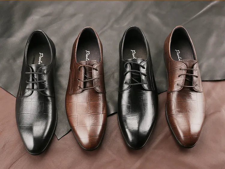 Men's black leather derby shoes with pointed toe and rubber sole on a white background.