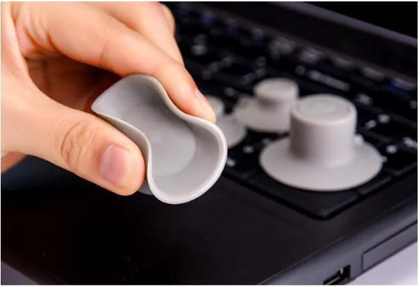 Grey durable plastic laptop cooling pad stand with two large and two small non-slip pads.