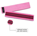 Set of three coloured fabric resistance bands and a net storage bag for home fitness.