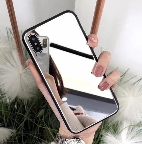 Black iPhone phone case with a built-in circular mirror on the back, shown next to an iPhone.