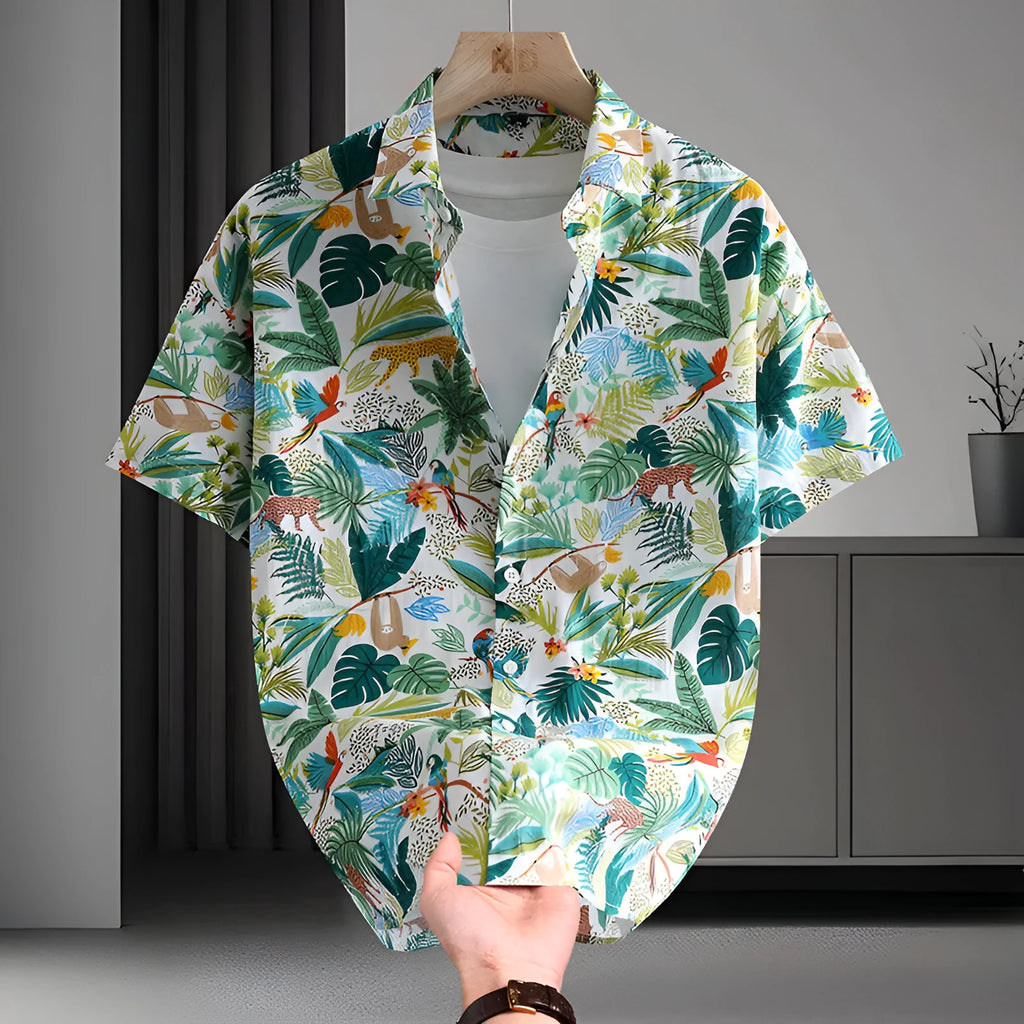 Man wearing a short sleeve cotton Hawaiian shirt with a blue and white floral print.