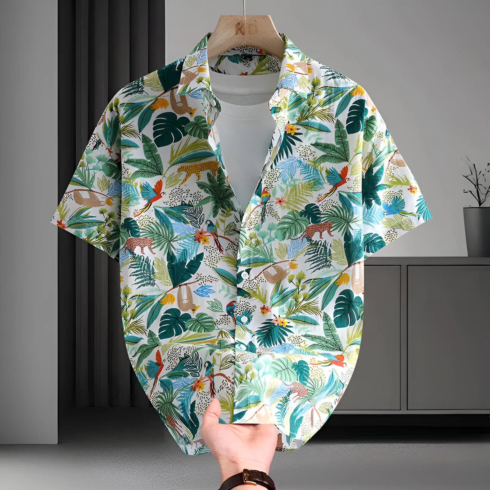 Man wearing a short sleeve cotton Hawaiian shirt with a blue and white floral print.