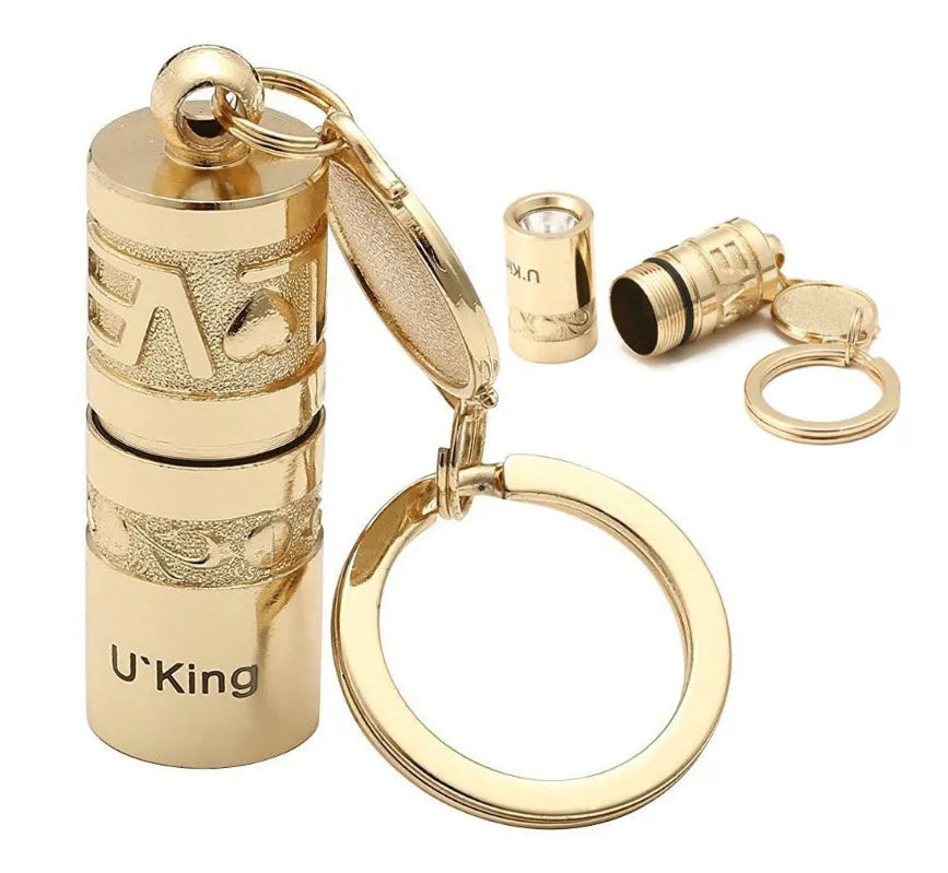 Gold-coloured zinc alloy die-cast LED keychain flashlight with attached key ring.