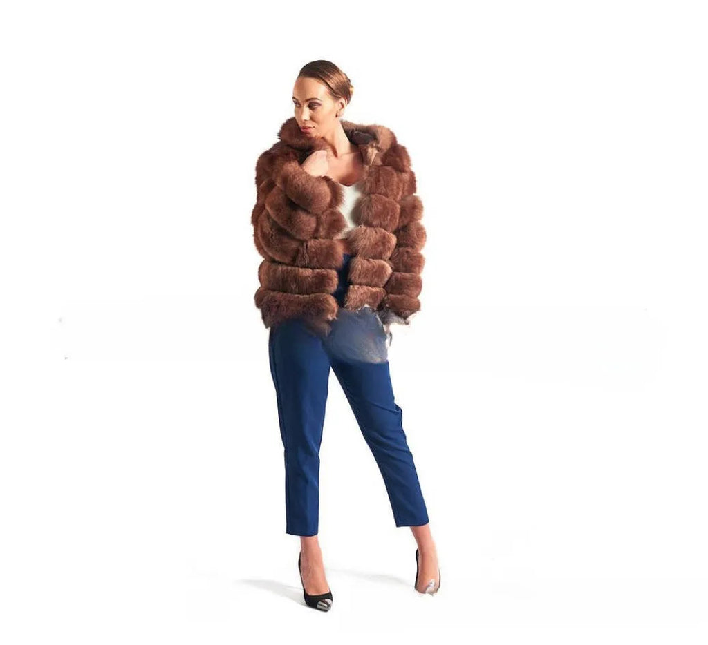 A woman wearing a loose-fit brown artificial fur hooded coat of medium length.