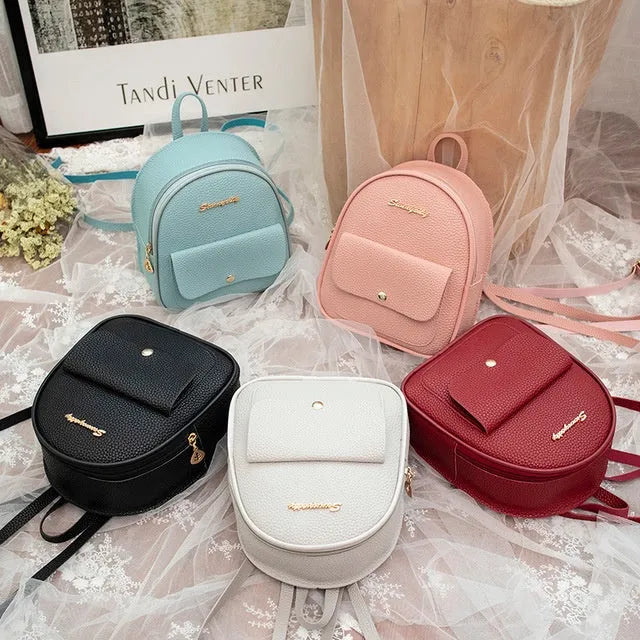 Black PU women's small backpack convertible to a shoulder bag, shown with a mobile phone for scale.
