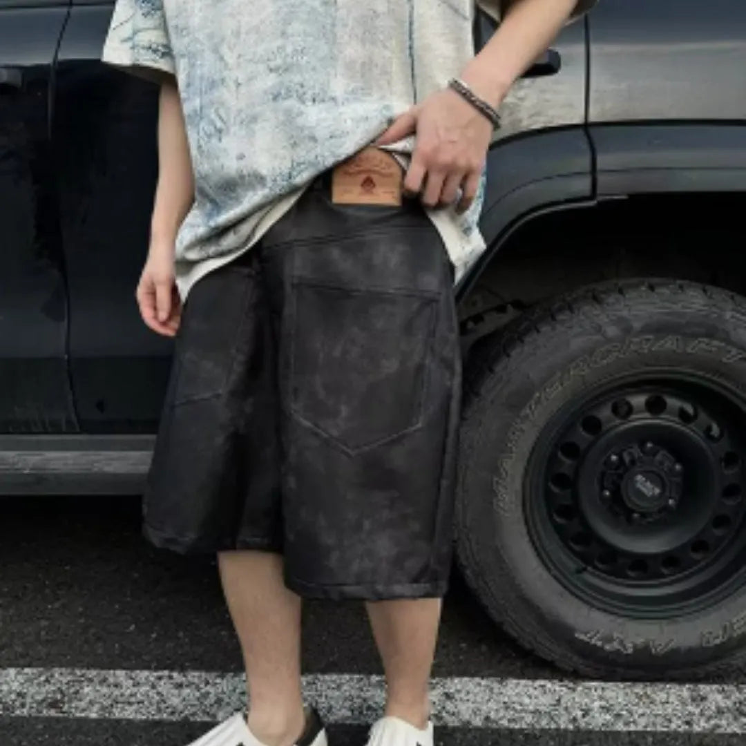 Man wearing a loose-fit Korean-style T-shirt with a dirty print effect and round neck.