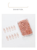 Rose gold heart-shaped metal paper clips measuring 28mm with steel core construction
