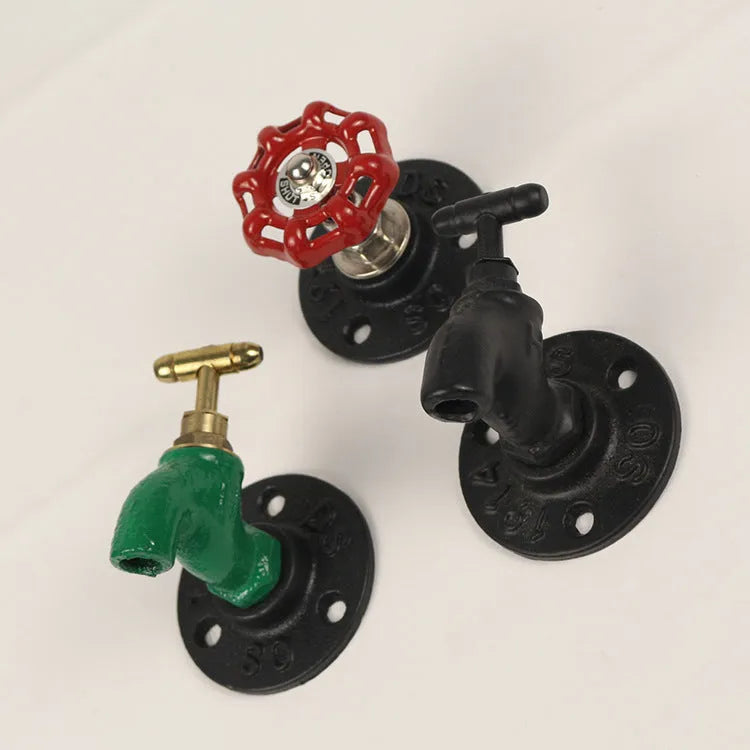 Water pipe style metal wall hook for towels on a white wall, shown in black, green, and red colour options.