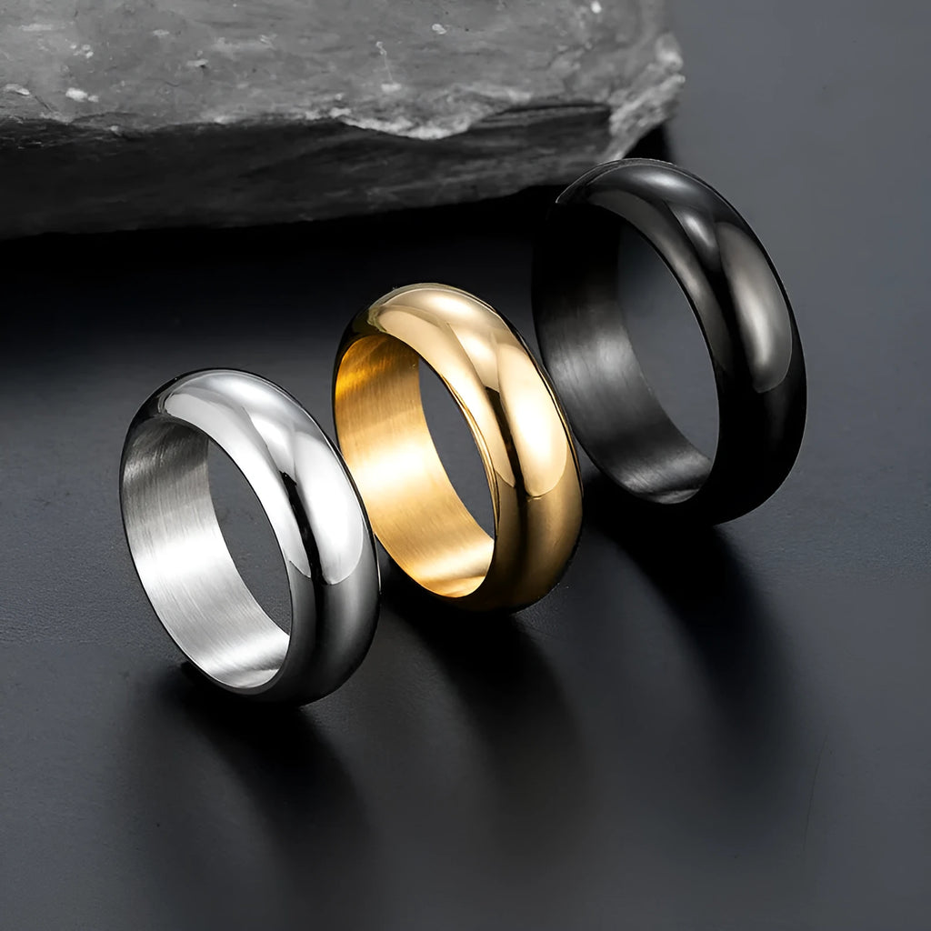 A glossy electroplated titanium steel ring shown in gold, black, and steel colour on a grey background.