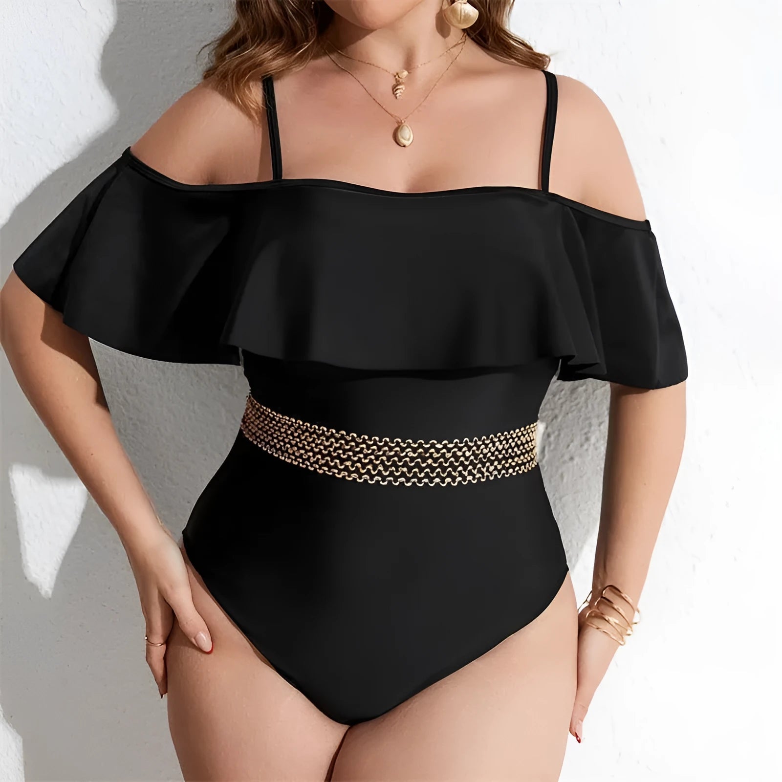 Black solid colour one-piece swimsuit for women in plus sizes on a mannequin.