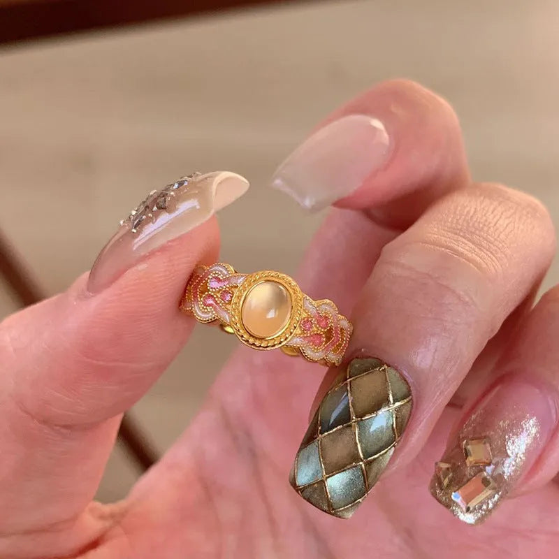 Women's geometric open ring with pink crystal enamel finish on adjustable copper gold plating