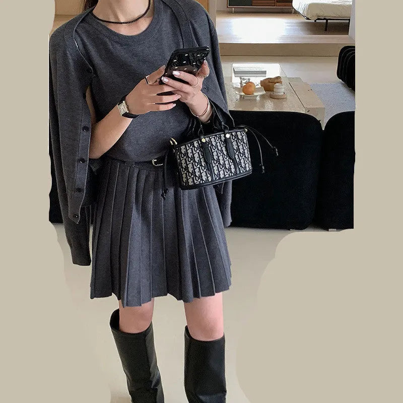 Women's black art retro knitted two-piece set with long-sleeve cardigan, pleated vest skirt, and a belt.