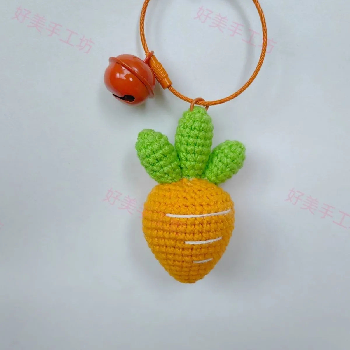 Wool cartoon carrot-shaped keychain pendant on a key ring.