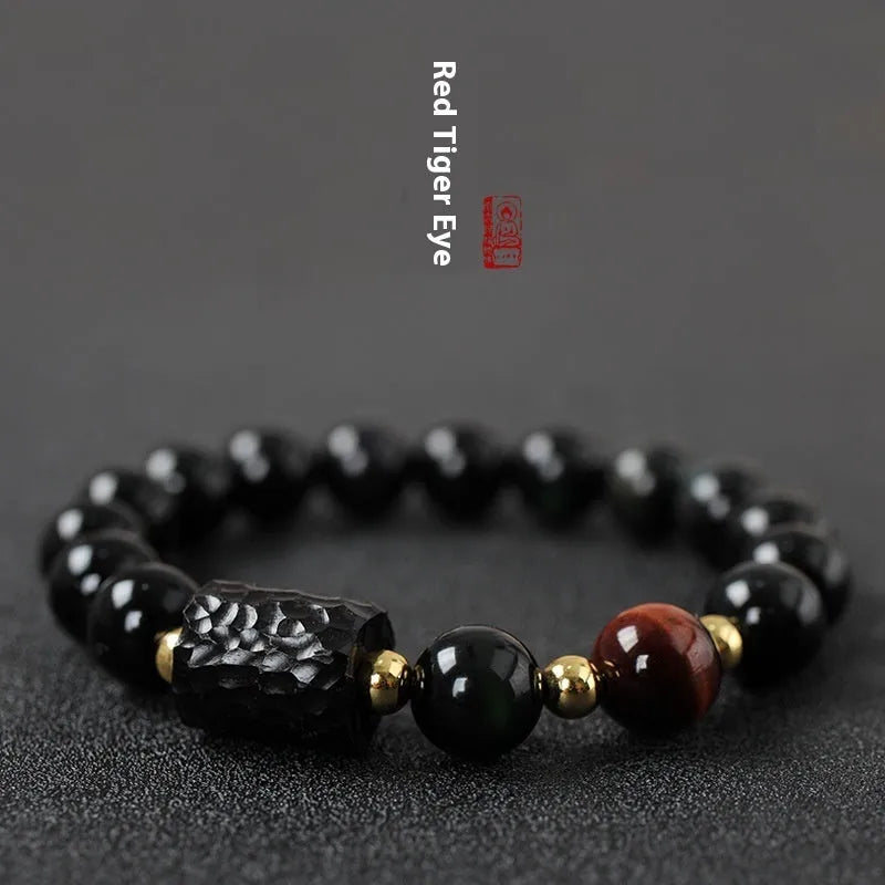 Obsidian bracelet with yellow tiger eye beads showing retro circular design