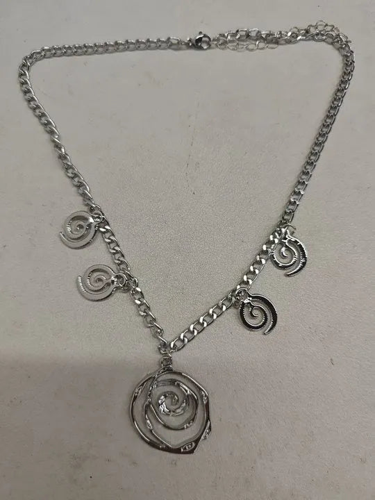 Spiral donut design women's jewellery set showing necklace, bracelet and ear hooks in gold or silver finish