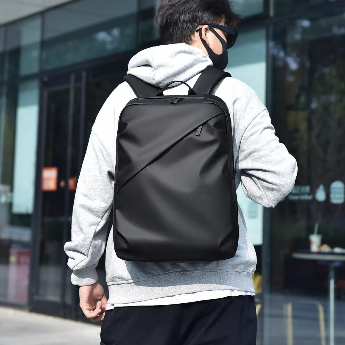 Large waterproof backpack in black, blue, or grey with PU leather construction and computer compartment