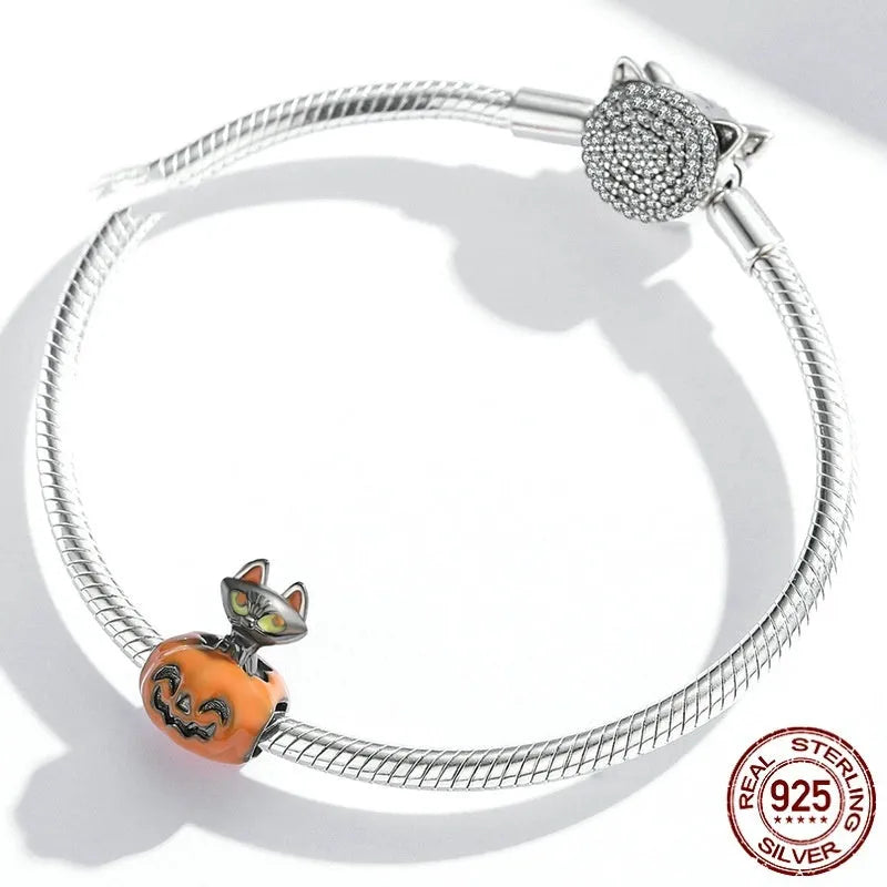 Close-up of sterling silver pumpkin black cat pendant with black gold plated oil dripping finish