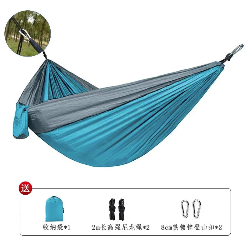 Blue parachute nylon outdoor hammock hung between trees, showing its 270cm length.