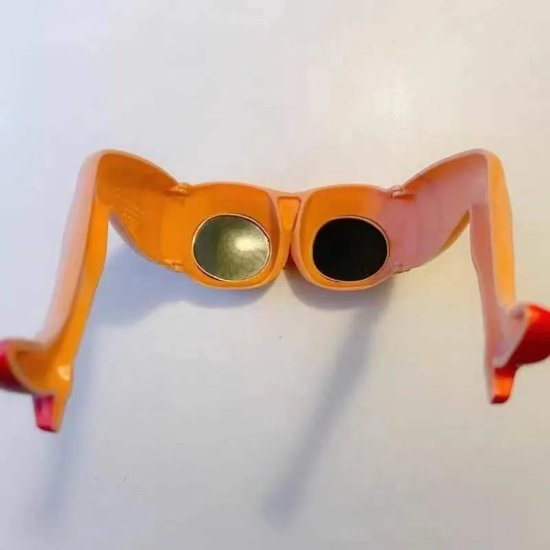 Orange novelty sunglasses with a unique leg hip style design on a white background.