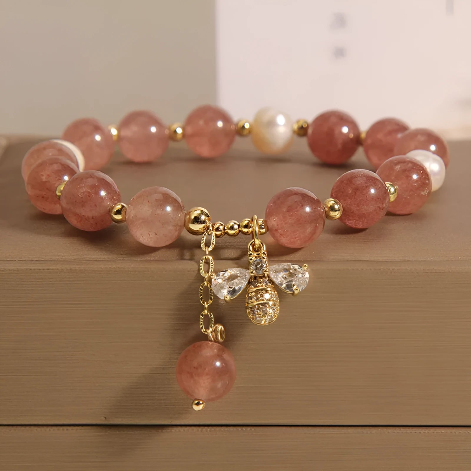 Women's alloy bracelet with three strawberry quartz stones, freshwater pearls, and zircon accents.