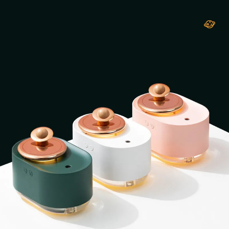 Green rotating planet-shaped USB humidifier with night light on a wooden desk.