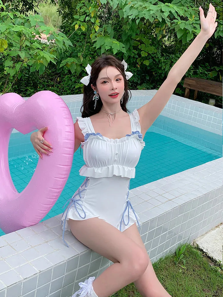 Milky White backless one-piece swimsuit for women on a hanger.