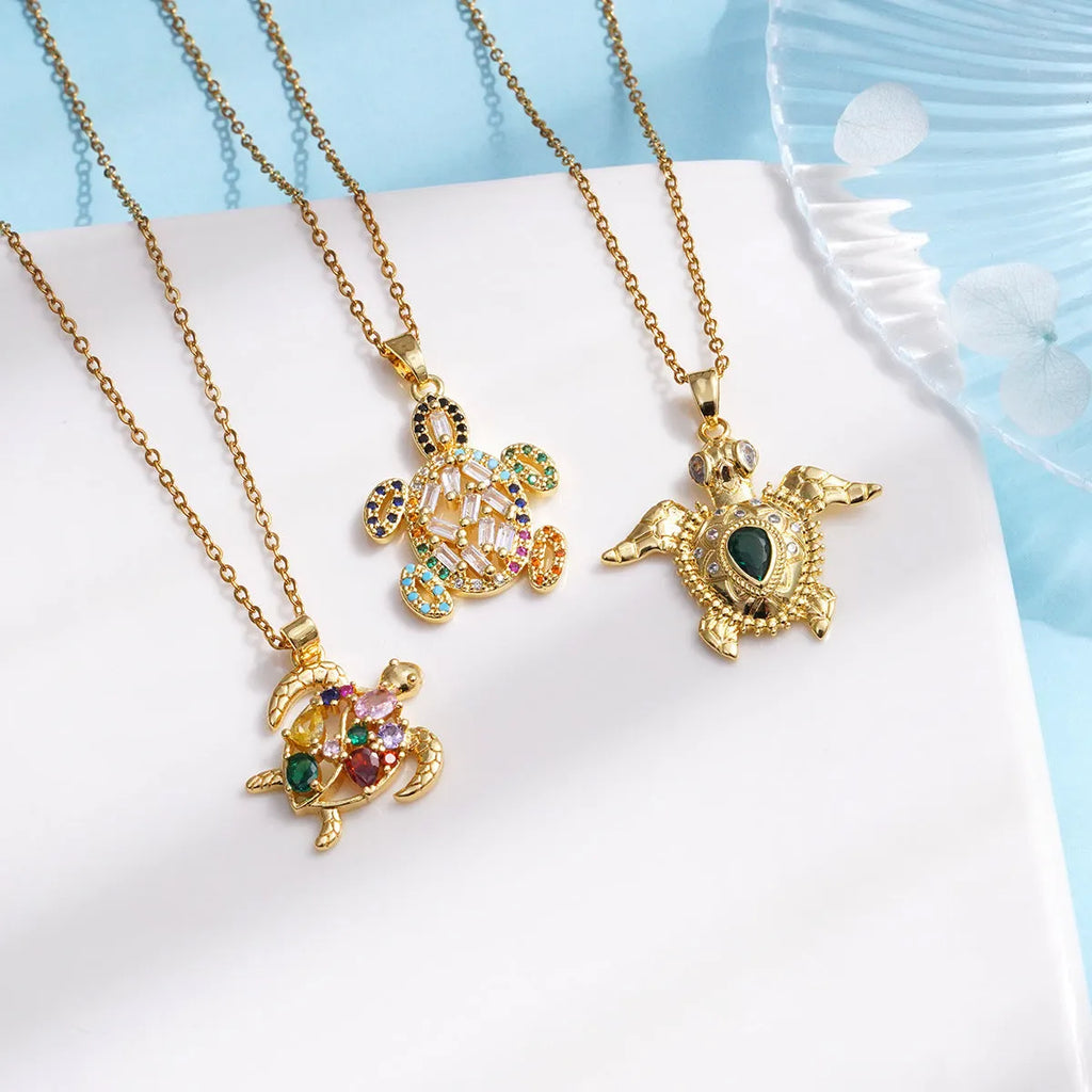 Gold-plated copper sea turtle necklace with zirconium accents and mixed gemstone inlay, O-link chain, light luxury style for women
