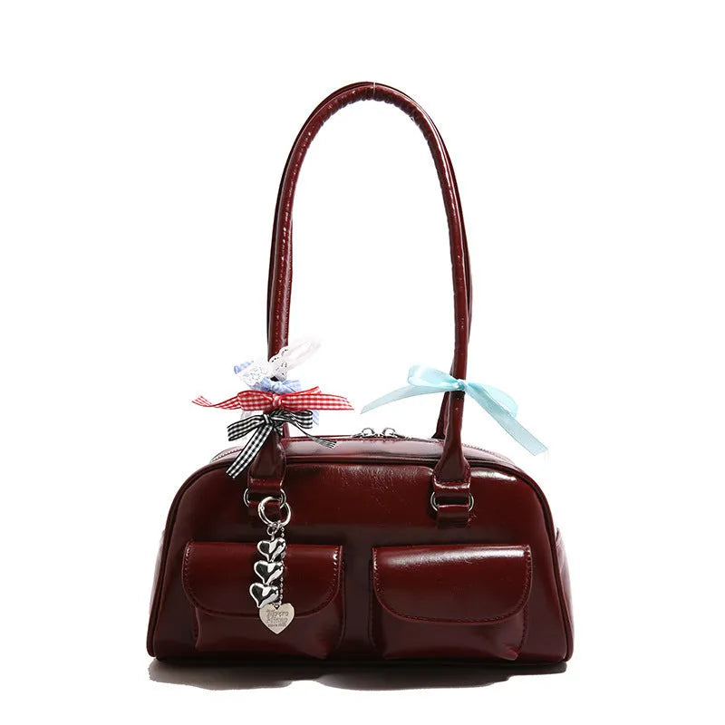 Retro brown PU leather women's pillow-shaped handbag with double shoulder strap and flap closure.