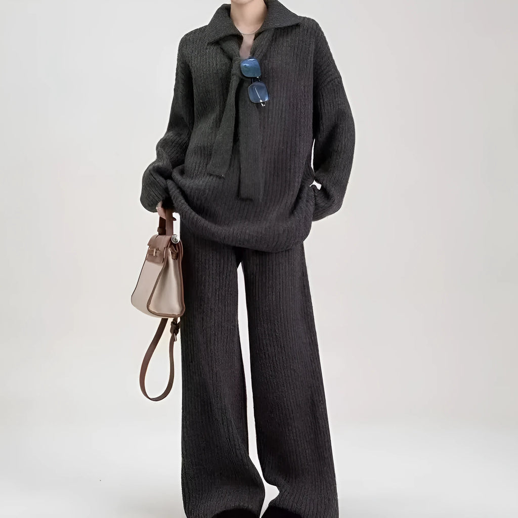 A dark grey sweater suit two-piece set featuring a long-sleeved knit top and matching casual trousers.