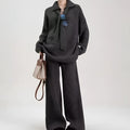 A dark grey sweater suit two-piece set featuring a long-sleeved knit top and matching casual trousers.
