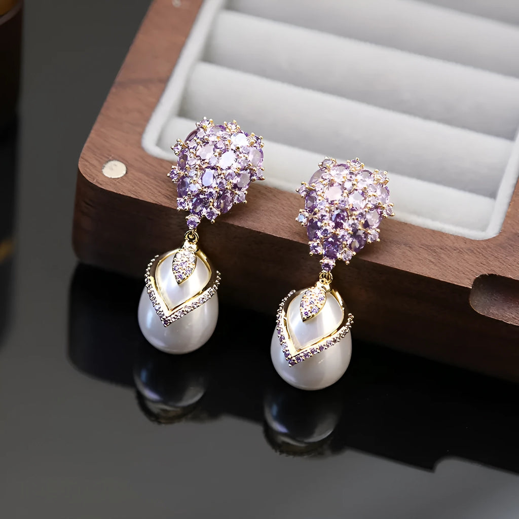 Women's drop-shaped pearl earrings with zircon stone accents and 18K gold plating.