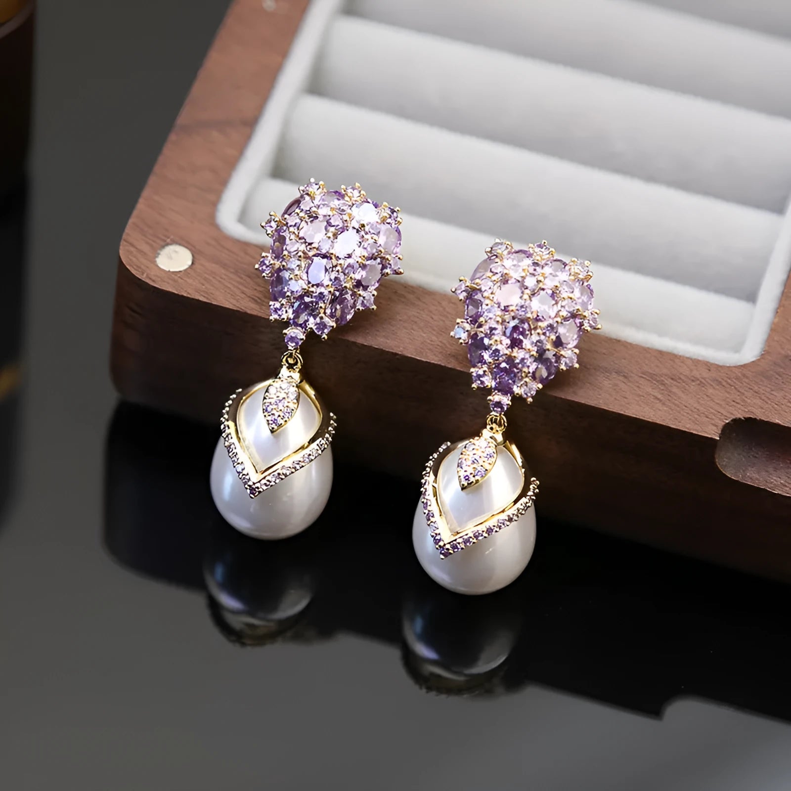 Women's drop-shaped pearl earrings with zircon stone accents and 18K gold plating.
