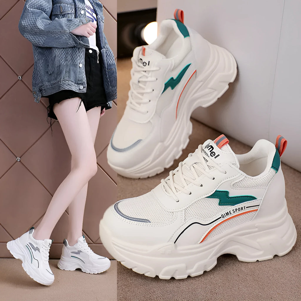 Women's white low-top sports trainers with cross shoulder straps and front laces, made of breathable mesh.