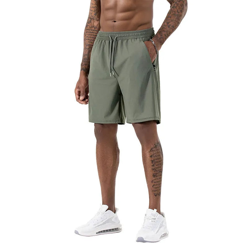 Man wearing black ice silk quick-drying sports shorts with drawstring waist.