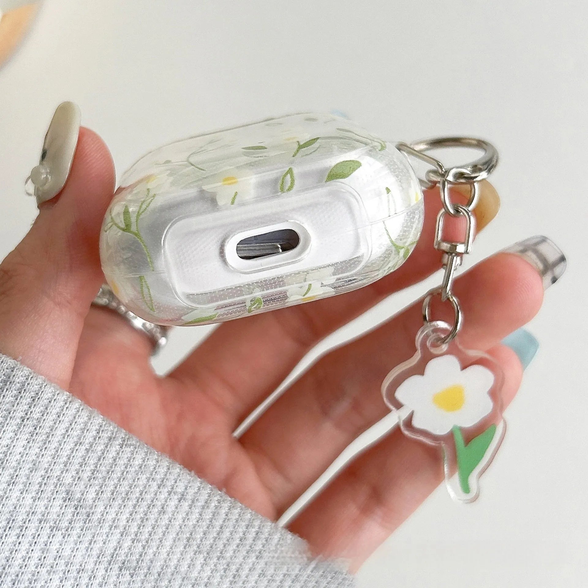 Transparent white floral TPU protective case for Apple AirPods showing decorative pattern
